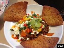 This hearty breakfast has Chorizo sausage, black beans, rice, cheese, eggs, guacamole, tomatoes on multi-grain tortillas. (Photo: Julia Taboh / VOA)