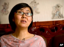 FILE - In this April 18, 2015 file photo, Wang Yu, a lawyer for Chinese activist Li Tingting, speaks during an interview in Beijing. China released the prominent human rights lawyer on bail amid protests on Aug, 1, 2016, outside a northern city court.
