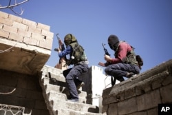 Militants from the Kurdistan Workers' Party, or PKK, run as they attack Turkish security forces in Nusaydin, Turkey, March 1, 2016.