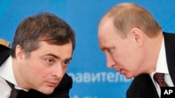 FILE - Russian President Vladimir Putin and former deputy chief of staff Vladislav Surkov, Feb. 13, 2012.