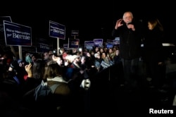 U.S. Democratic presidential candidate Bernie Sanders, with his wife Jane, addressess supporters from the bed of a pickup truck after arriving early morning in Bow, New Hampshire from Iowa Feb. 2, 2016.