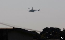 An Indian air force chopper on a reconnaissance mission flies over the Indian airbase in Pathankot, 430 kilometers (267 miles) north of New Delhi, India, Jan. 2, 2016.