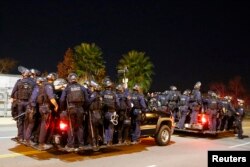 Police follow protesters during a march in Los Angeles, California, following Monday's grand jury decision in the shooting of Michael Brown in Ferguson, Missouri, November 25, 2014.