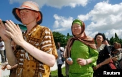 FILE - Participants march toward Mnazi Mmoja grounds during Tanzania Albino Day celebrations in Dar es Salaam.