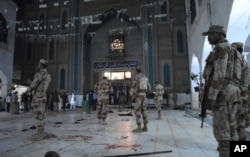 Pakistani para-military soldiers stand alert after a deadly suicide attack at the shrine of famous Sufi Lal Shahbaz Qalandar in Sehwan, Pakistan, Feb. 16, 2017.