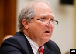 FILE - John F. Sopko, Special Inspector General for Afghanistan Reconstruction (SIGAR), testifies on Capitol Hill in Washington before the House Foreign Affairs subcommittee on the Middle East and North Africa hearing on Examining U.S. Reconstruction Efforts in Afghanistan, June 10, 2014.