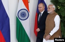 Russian President Vladimir Putin and India's Prime Minister Narendra Modi arrive ahead of their meeting at Hyderabad House in New Delhi, India, Oct. 5, 2018.