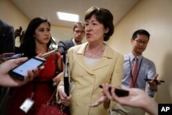 FILE - Sen. Susan Collins, R-Maine, a member of the Senate Select Committee on Intelligence, talks to reporters in a corridor at the Capitol in Washington, June 21, 2017.