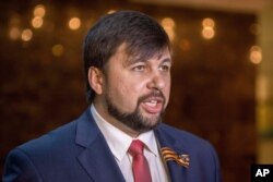 FILE - Denis Pushilin, Donetsk Russian-backed separatist representative, meets with the media after talks in Minsk, Belarus, May 6, 2015.