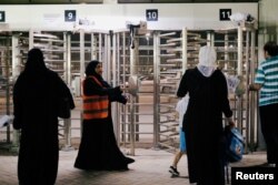 Saudi women arrive to watch the soccer match between Al-Ahli against Al-Batin at the King Abdullah Sports City in Jeddah, Saudi Arabia, Jan. 12, 2018.