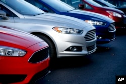 FILE - Ford Fusions are for sale on the lot at Butler County Ford in Butler, Pa., in November 2015.