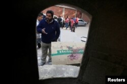 A man looks at bullet holes and bloodstains at the site of an attack on the Mary Mina Church in Helwan district on the outskirts of Cairo, Egypt, Dec. 29, 2017.