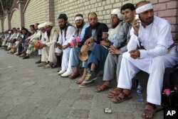 FILE - Members of the Helmand Peace Convoy, who trekked across the country on foot calling for an end to the war, arrive in Kabul, Afghanistan, June 18, 2018.