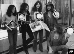 FILE - British rock band Deep Purple present their golden record they received in West Berlin for the sales of their latest album, "Deep Purple in Rock," in West Germany, Sept. 1, 1971.