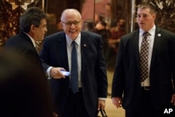FILE - Former New York Mayor Rudy Giuliani, center, smiles as he leaves Trump Tower, Nov. 11, 2016, in New York.
