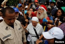 Elderly opposition supporters confront security forces while rallying against President Nicolas Maduro in Caracas, Venezuela, May 12, 2017.