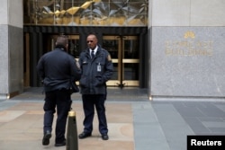 FILE - Police and security stand outside 30 Rockefeller Plaza, the location for the offices of U.S. President Donald Tump's personal lawyer Michael Cohen which was raided by the FBI, in Manhattan, New York, April 9, 2018.