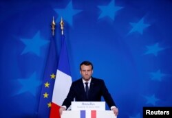 FILE - French President Emmanuel Macron addresses a news conference during European Union leaders informal summit in Brussels, Belgium, Feb. 23, 2018.