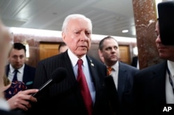 FILE - Senate Health, Education, Labor and Pensions Committee member Sen. Orrin Hatch, center, leaves the committee's executive session on Education Secretary-designate Betsy DeVos, on Capitol Hill in Washington, Jan. 31, 2017.
