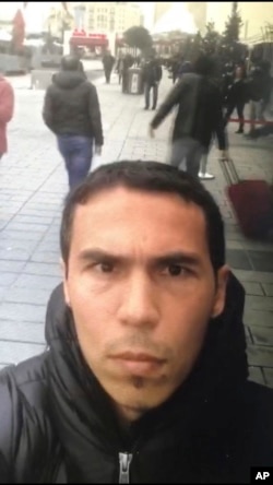 In this undated photo a man, believed to be the gunman who killed dozens at an Istanbul nightclub, films himself and the street behind him as he wanders nearby Istanbul's crowded Taksim square.