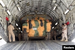 Turkish troops seen unloading a vehicle at their military base in Doha, Qatar, June 23, 2017.