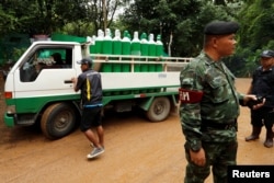 A truck carrying oxygen tanks arrives outside the Tham Luang cave complex, where 12 schoolboys and their soccer coach are trapped inside a flooded cave, in the northern province of Chiang Rai, Thailand, July 8, 2018.