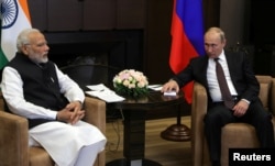 FILE - Russian President Vladimir Putin meets with Indian Prime Minister Narendra Modi in the Black Sea resort of Sochi, Russia, May 21, 2018. Modi is expected to host Putin for talks Friday.