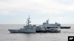 A Royal Malaysian Navy's missile corvette and an offshore patrol vessel are seen during a search and rescue operation for the missing Malaysia Airliner over the Straits of Malacca, Malaysia, March 13, 2014.