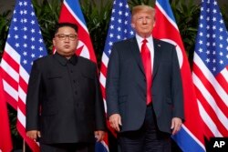 FILE - U.S. President Donald Trump, right, meets with North Korean leader Kim Jong Un on Sentosa Island, in Singapore, June. 12, 2018.