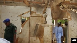 FILE - People inspect a damaged mosque following a suicide bomb explosion led by two women in Maiduguri, Nigeria, March 16, 2016. UNICEF says Boko Haram has increased "tenfold" the use of children as suicide bombers.