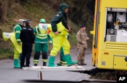 FILE - Military forces work on a van in Winterslow, England, March 12, 2018, as investigations continue into the nerve-agent poisoning of Russian ex-spy Sergei Skripal and his daughter, Yulia, in Salisbury, England, on March 4,2018.