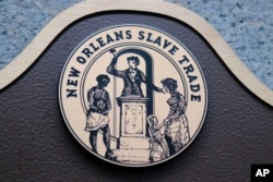 This photo, taken Sept. 27, 2018, shows the logo that tops new markers on five New Orleans buildings, with a sixth marker in the works.