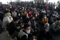 Masyarakat sedang mengantre untuk mendapatkan vaksin COVID-19 di Bandara Internasional Juanda, saat kasus melonjak di Sidoarjo, Jawa Timur, 22 Juli 2021. (Foto: Antara/Umarul Faruq via REUTERS)