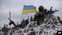 A Ukrainian military vehicles drives toward Debaltseve on the outskirts of Artemivsk, eastern Ukraine, Feb. 8, 2015.