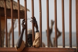 A parent waits outside the Government Science School in Kankara, in northwestern Katsina state, Nigeria, Dec. 16, 2020.