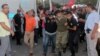 FILE - Soldiers suspected of being involved in the coup attempt are escorted by policemen as they arrive at a courthouse in the resort town of Marmaris, Turkey, July 17, 2016. 