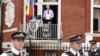 WikiLeaks founder Julian Assange steps onto the balcony before speaking to the media outside the Ecuador embassy in west London, August 19, 2012.