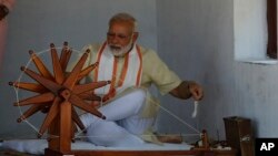 Indian prime minister Narendra Modi tries his hands on a spinning wheel during his visit to Gandhi Ashram, a residence of Mahatma Gandhi, in Ahmadabad, India, June 29, 2017. 
