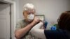 Fred Laredo, 72, receives the Moderna COVID-19 vaccination from Dr. Lishunda Franklin at Crescent City Pharmacy in New Orleans, Louisiana, Jan. 8, 2021.