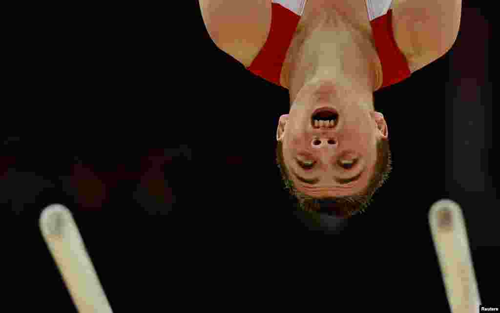 Britain's Sam Oldham competes on the parallel bars during the men's gymnastics qualification in the North Greenwich Arena during the London 2012 Olympic Games July 28, 2012.