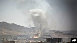 File - Smoke rises after a Saudi-led airstrike hit a site where many believe the largest weapons cache in Yemen's capital, Sana'a, on April 21, 2015. 