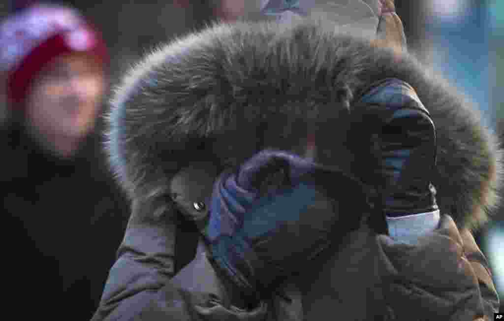 A pedestrian covers up against single digit temperatures in New York, Jan. 7, 2014.