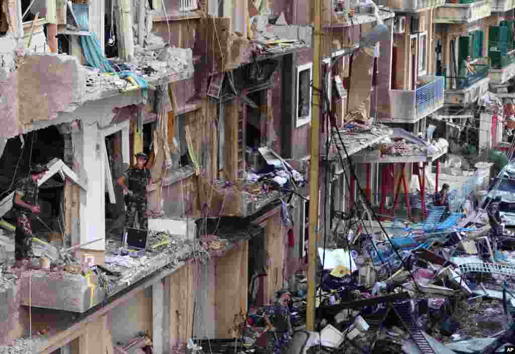 Lebanese soldiers inspect damaged buildings at the scene of an explosion in Beirut, Lebanon, October 19, 2012.