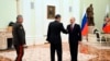 Russian President Vladimir Putin, right, greets China's Defense Minister Gen. Li Shangfu, center, as Russian Defense Minister Sergei Shoigu stands near at the Kremlin in Moscow, Russia, Sunday, April 16, 2023. (Pavel Bednyakov, Sputnik, Kremlin Pool Photo via AP)