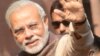 India's new Prime Minister Narendra Modi (C) gestures during his arrival at the Prime Minister's Office at South Block in New Delhi on May 27, 2014.