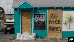Sebuah papan bertuliskan "Be Nice Harvey" di salah sebuah kios di Pelabuhan Aransas, Texas, 24 Agustus 2017.