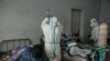 Un patient gravement infecté par le coronavirus est traité par des agents de santé à l'hôpital universitaire d'Andohatapenaka à Antananarivo le 20 juillet 2020.