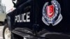 FILE - A police vehicle is seen parked on a street in Singapore, May 31, 2019.