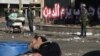A man sleeps on a plastic chair as Egyptian army soldiers are deployed outside of the presidential palace in Cairo, December 12, 2012.