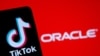 A smartphone with the Tik Tok logo is seen in front of a displayed Oracle logo in this illustration taken, Sept. 14, 2020. 